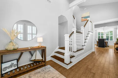 a view of entryway and hall with wooden floor