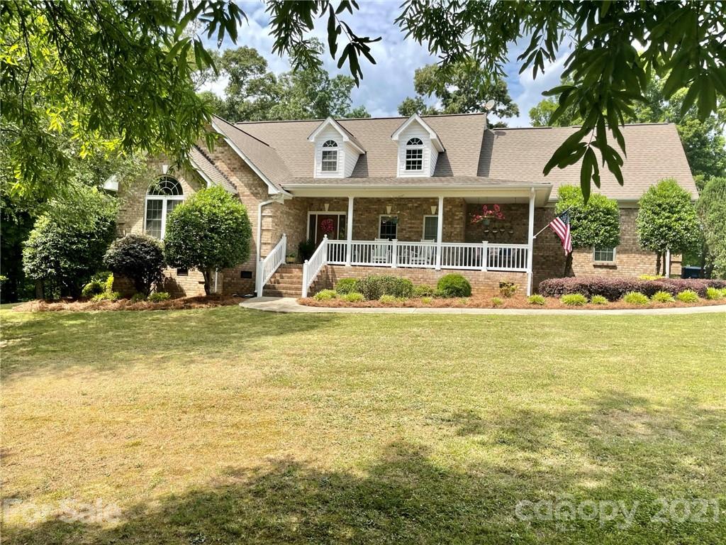 6023 Olive Branch Road Wingate, NC 28174 - Photo 1 of 44 a view of a house with a swimming pool