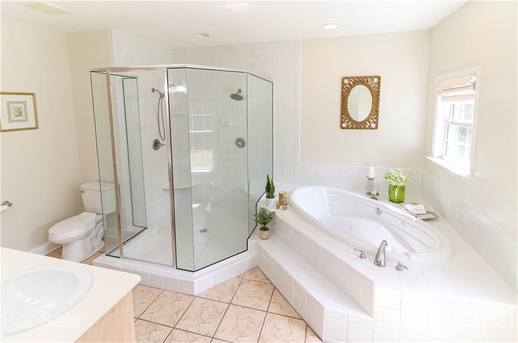 6023 Olive Branch Road Wingate, NC 28174 - Photo 15 of 44 a bathroom with a tub a toilet and a shower