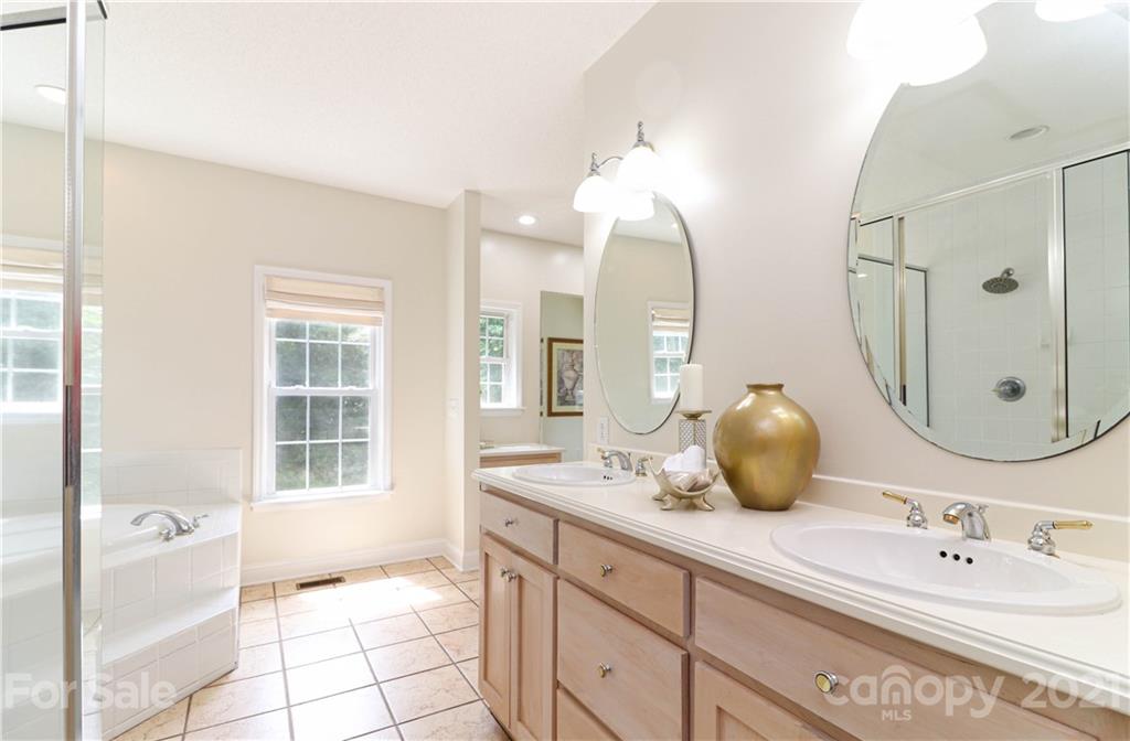 6023 Olive Branch Road Wingate, NC 28174 - Photo 17 of 44 a bathroom with a double vanity sink mirror and bathtub