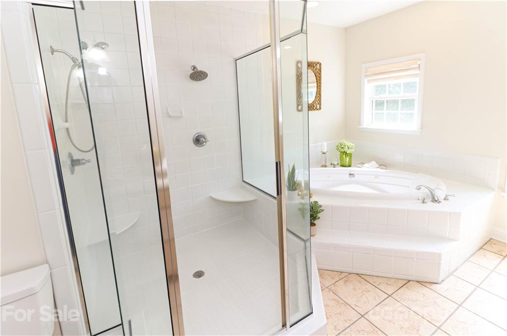 6023 Olive Branch Road Wingate, NC 28174 - Photo 18 of 44 a bathroom with a tub and a shower