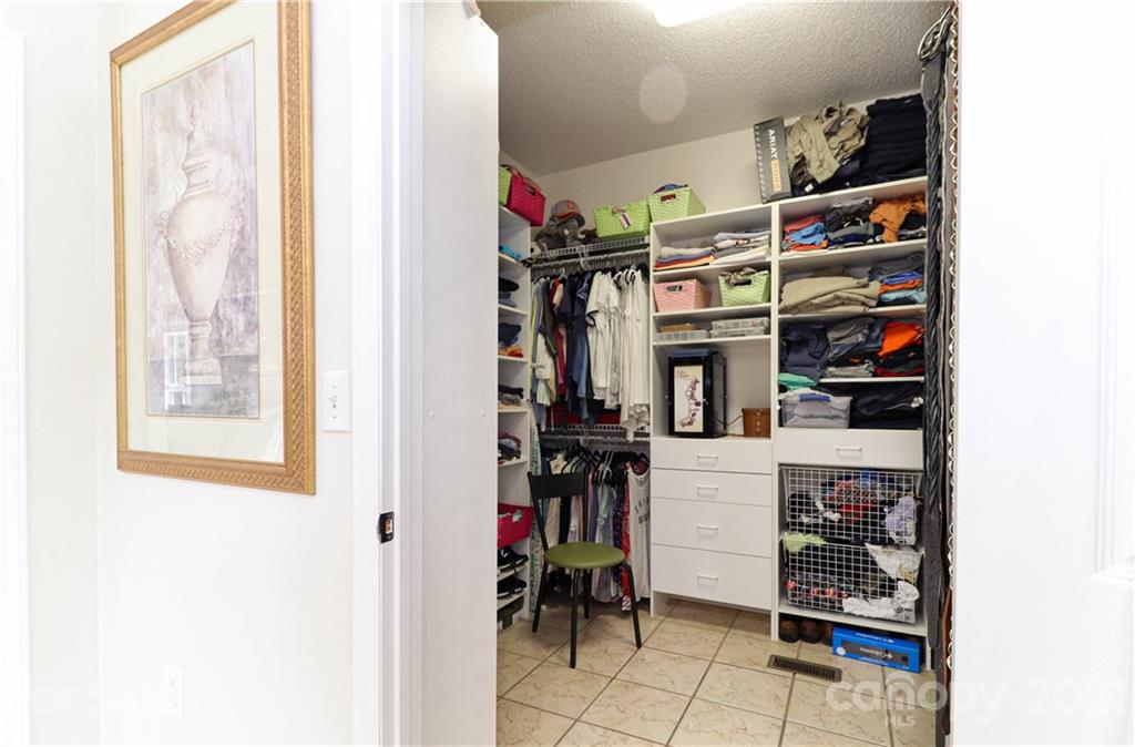 6023 Olive Branch Road Wingate, NC 28174 - Photo 19 of 44 a view of walk in closet with clothes and shoes