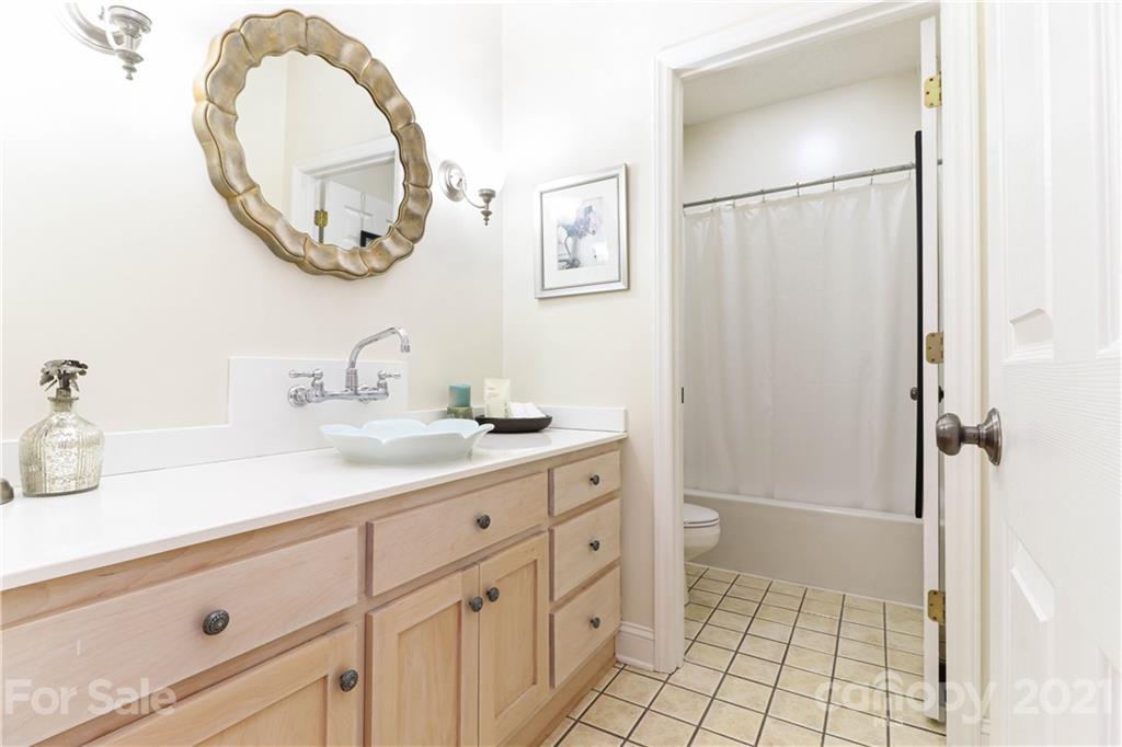 6023 Olive Branch Road Wingate, NC 28174 - Photo 29 of 44 a bathroom with a double vanity sink and a mirror
