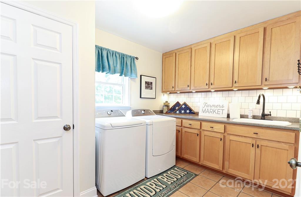 6023 Olive Branch Road Wingate, NC 28174 - Photo 31 of 44 a kitchen with a sink cabinets and window