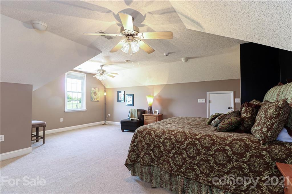 6023 Olive Branch Road Wingate, NC 28174 - Photo 34 of 44 a bedroom with a bed and ceiling fan