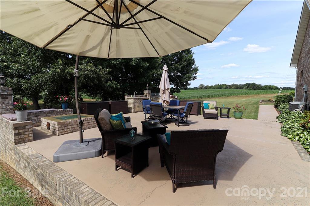6023 Olive Branch Road Wingate, NC 28174 - Photo 37 of 44 a patio with patio a table and chairs under an umbrella