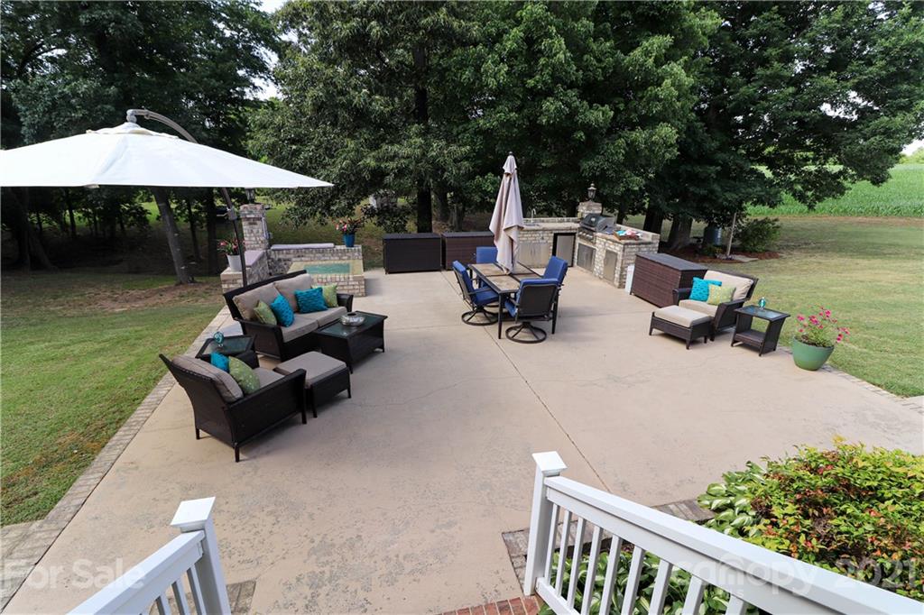 6023 Olive Branch Road Wingate, NC 28174 - Photo 5 of 44 a view of backyard with outdoor seating and trees