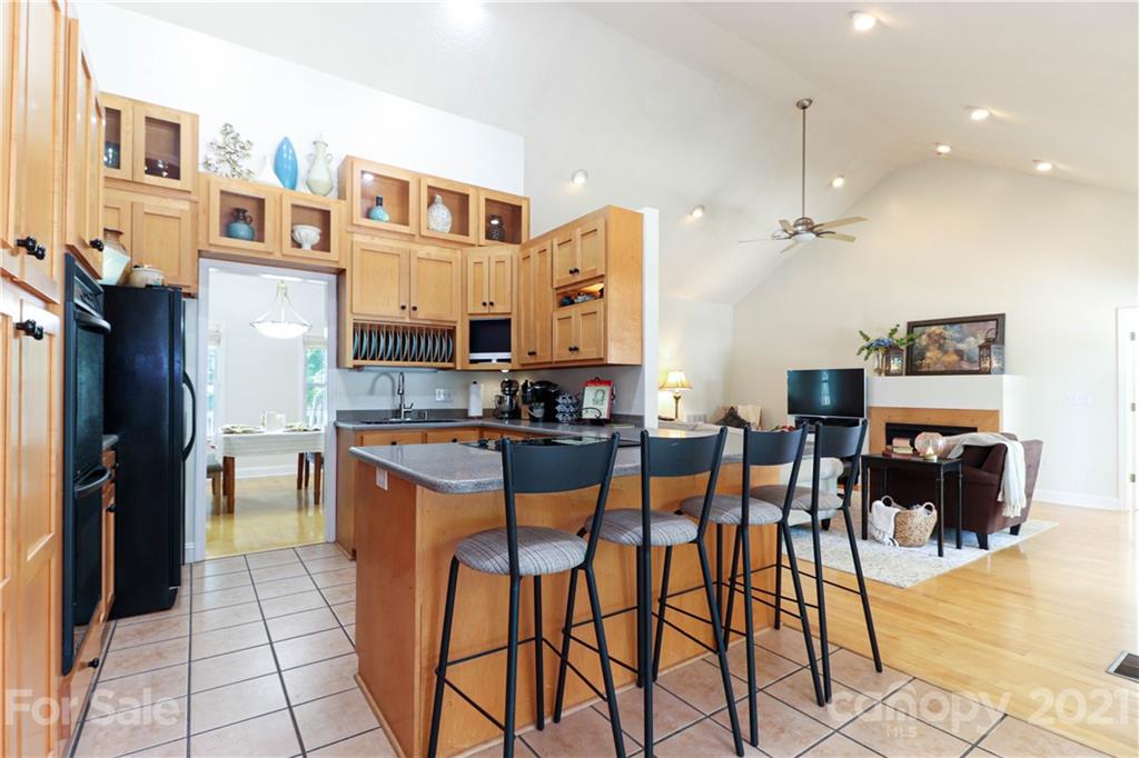 6023 Olive Branch Road Wingate, NC 28174 - Photo 7 of 44 a kitchen with stainless steel appliances kitchen island granite countertop a table chairs and a refrigerator
