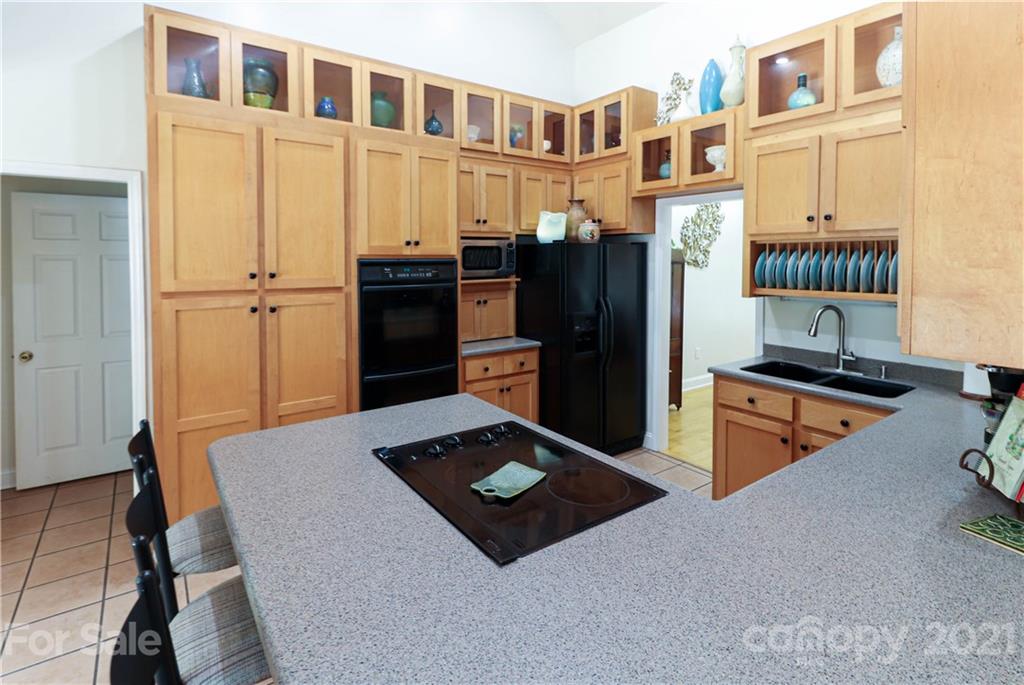 6023 Olive Branch Road Wingate, NC 28174 - Photo 8 of 44 a kitchen with stainless steel appliances granite countertop a refrigerator and a stove