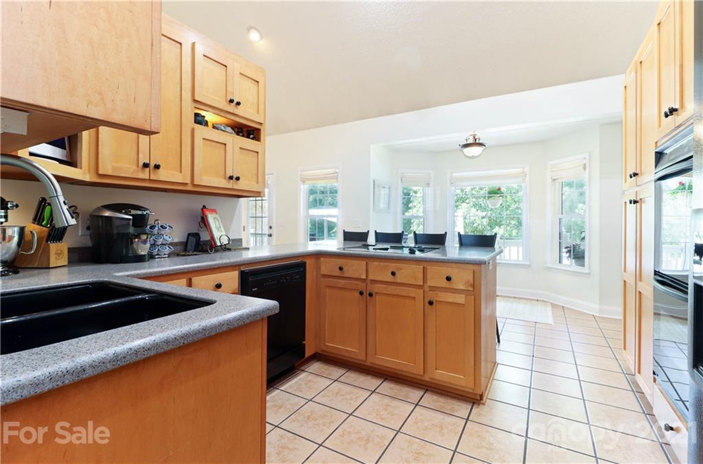 6023 Olive Branch Road Wingate, NC 28174 - Photo 9 of 44 a kitchen with stainless steel appliances granite countertop a sink and cabinets
