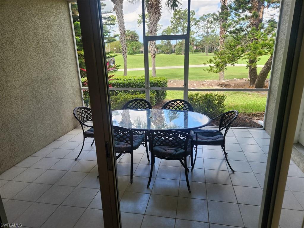 8085 Celeste Drive, Unit 812 Naples, FL 34113 - Photo 2 of 6 a dining room with furniture and window