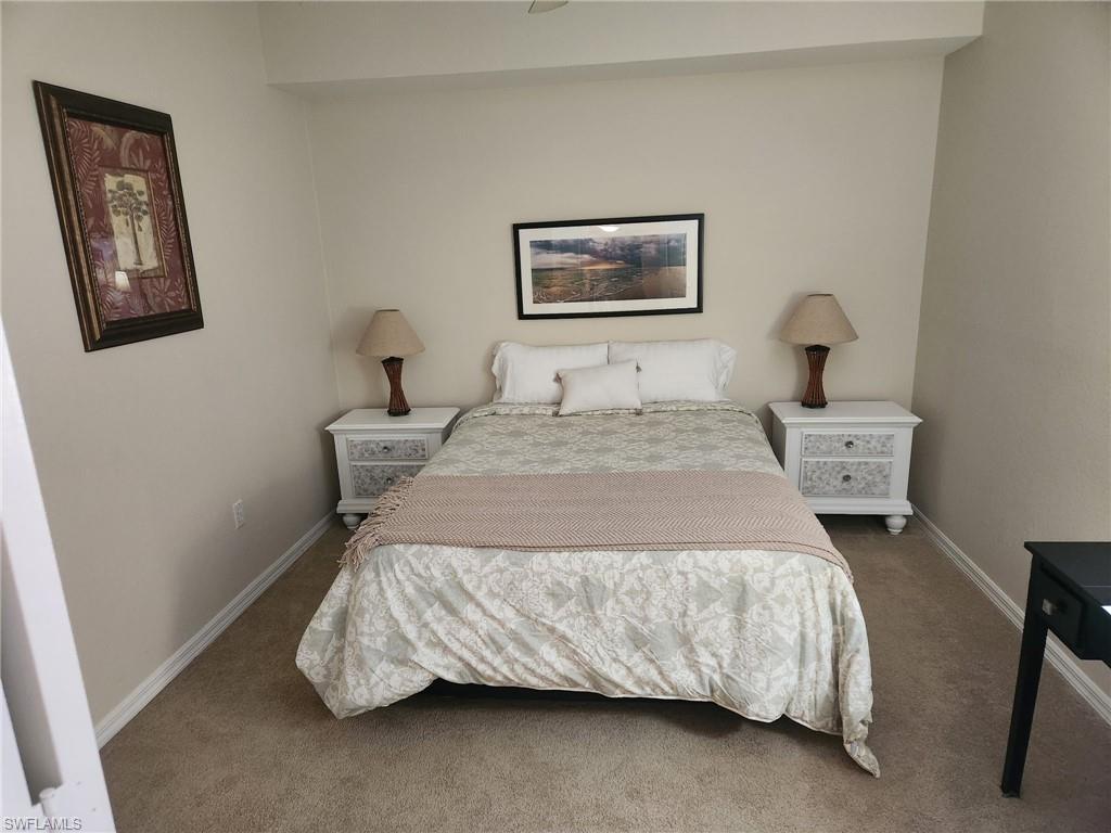 8085 Celeste Drive, Unit 812 Naples, FL 34113 - Photo 4 of 6 a bedroom with a bed and painting on the wall