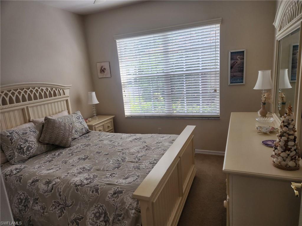 8085 Celeste Drive, Unit 812 Naples, FL 34113 - Photo 6 of 6 a bedroom with a bed and a table