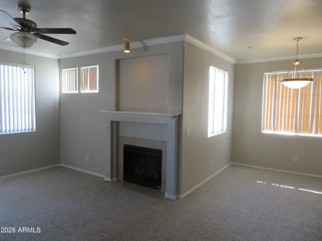 a view of an empty room with a fireplace and a window