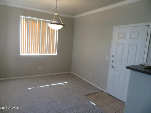 an empty room with windows and fireplace