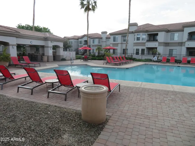 a swimming pool with outdoor seating and yard
