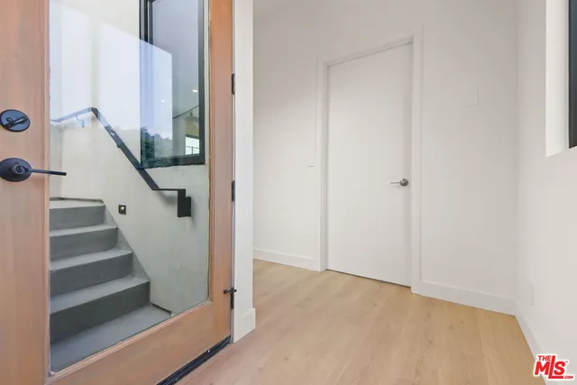 a view of entryway and gallery with wooden floor
