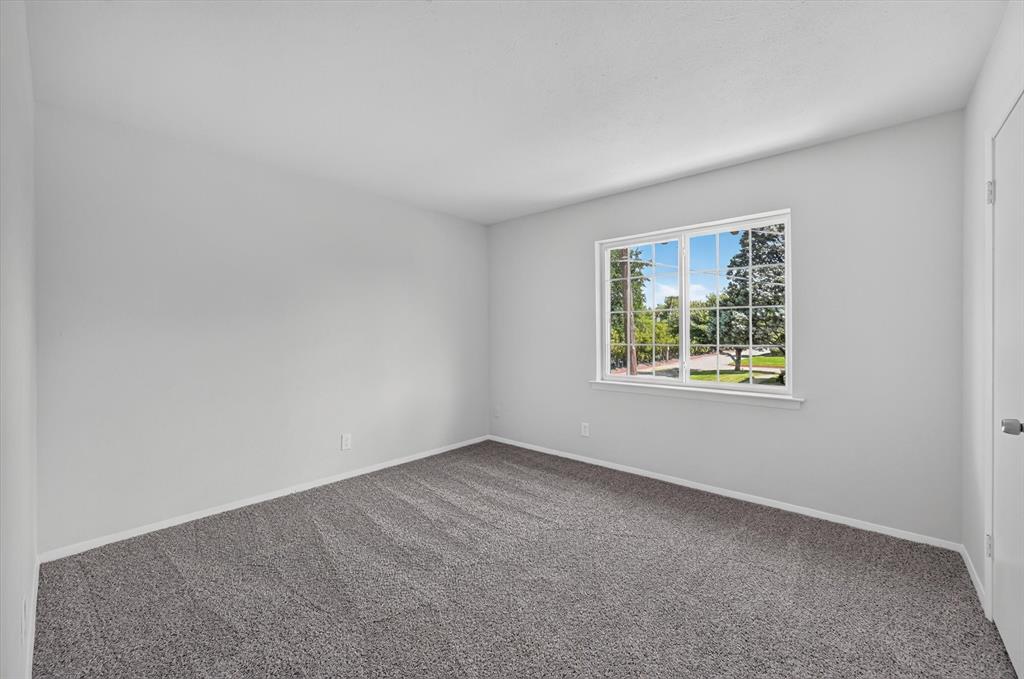 1801 East Grauwyler Road, Unit 101 Irving, TX 75061 - Photo 19 of 39 an empty room with windows