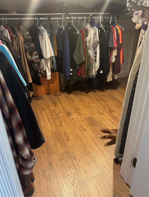 1794 Cr 527 Road Baird, TX 79504 - Photo 30 of 38 Closet featuring wood-finish flooring, white wire shelving, and hanging rods