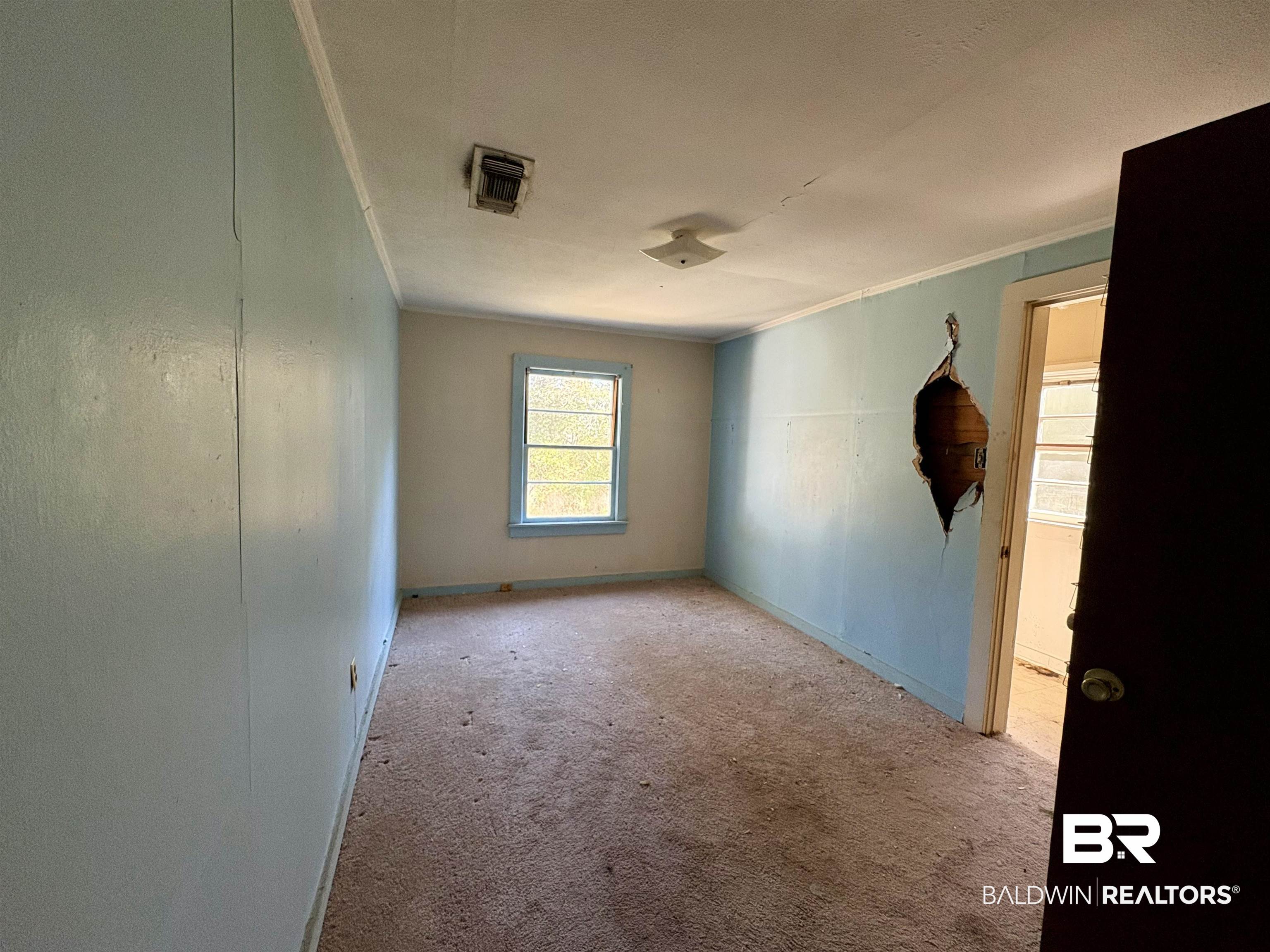 4060 Dickson Lane Mobile, AL 36618 - Photo 10 of 16 Carpeted spare room with crown molding and baseboards