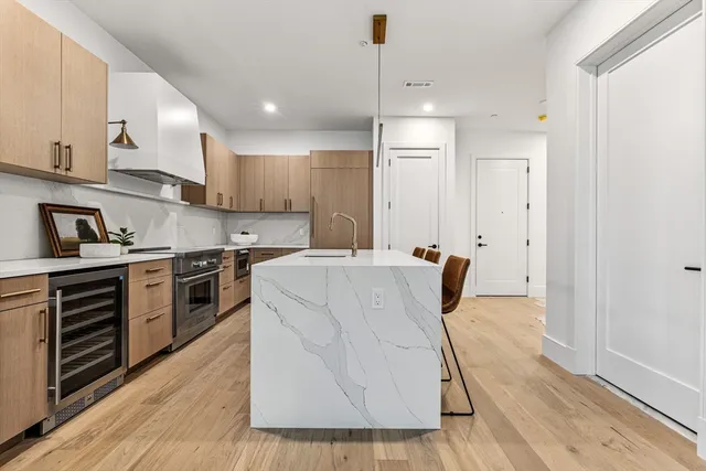 a kitchen with a table chairs refrigerator and cabinets