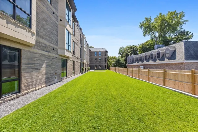 a view of an apartment with a backyard
