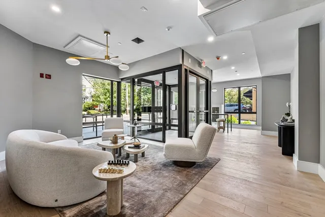 a living room with furniture a rug and a large window