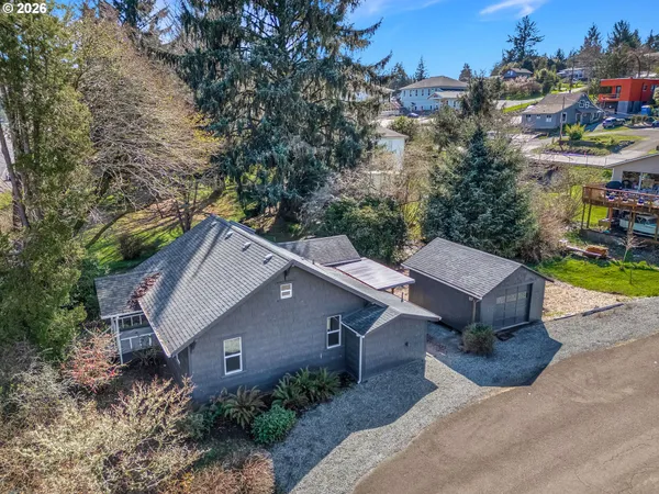 an aerial view of a house with a yard and trees