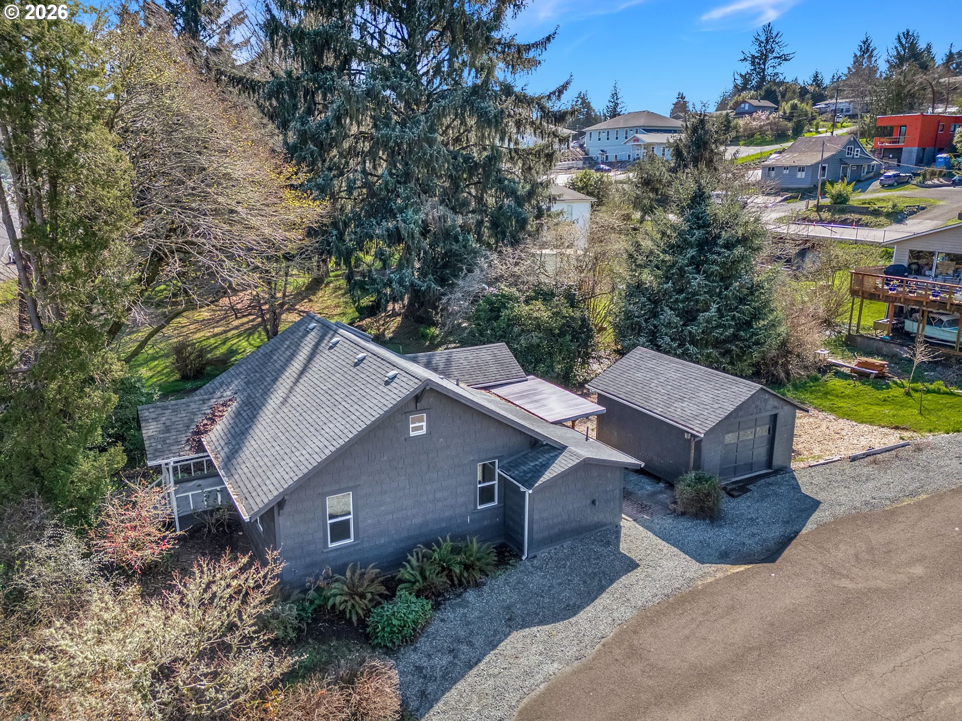 an aerial view of a house with a yard and trees