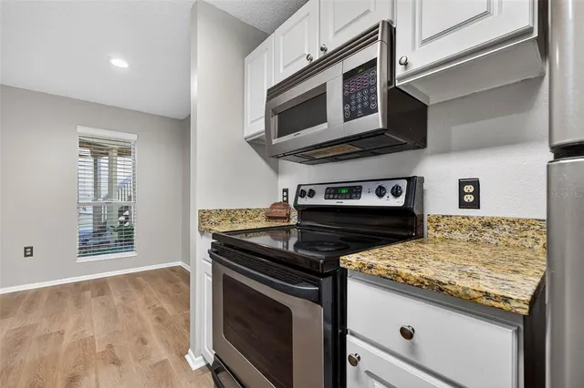 a kitchen with a sink and a granite counter tops