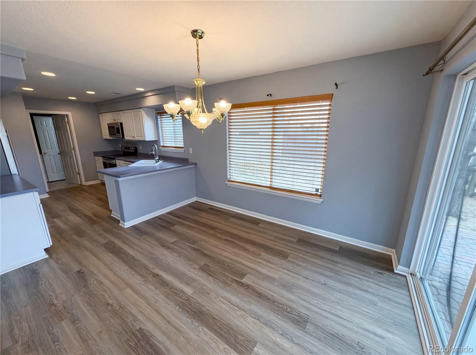 20000 Mitchell Place, Unit 45 Denver, CO 80249 - Photo 11 of 29 a living room with kitchen island granite countertop wooden floor and a fireplace