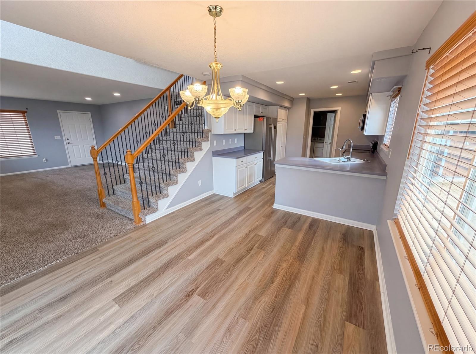 20000 Mitchell Place, Unit 45 Denver, CO 80249 - Photo 12 of 29 a view of a living room and kitchen with a large window