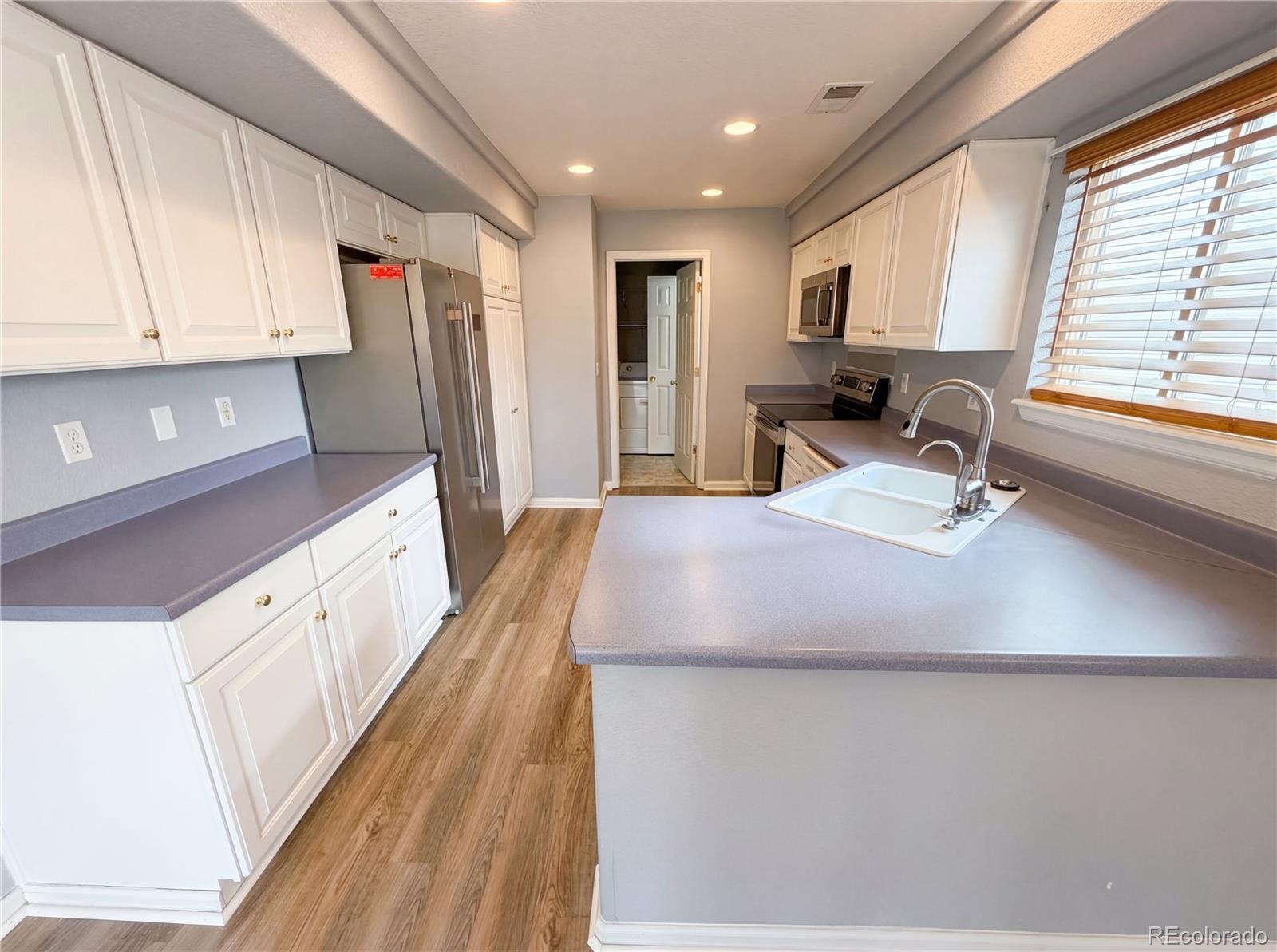 20000 Mitchell Place, Unit 45 Denver, CO 80249 - Photo 14 of 29 a kitchen with stainless steel appliances a refrigerator sink and cabinets