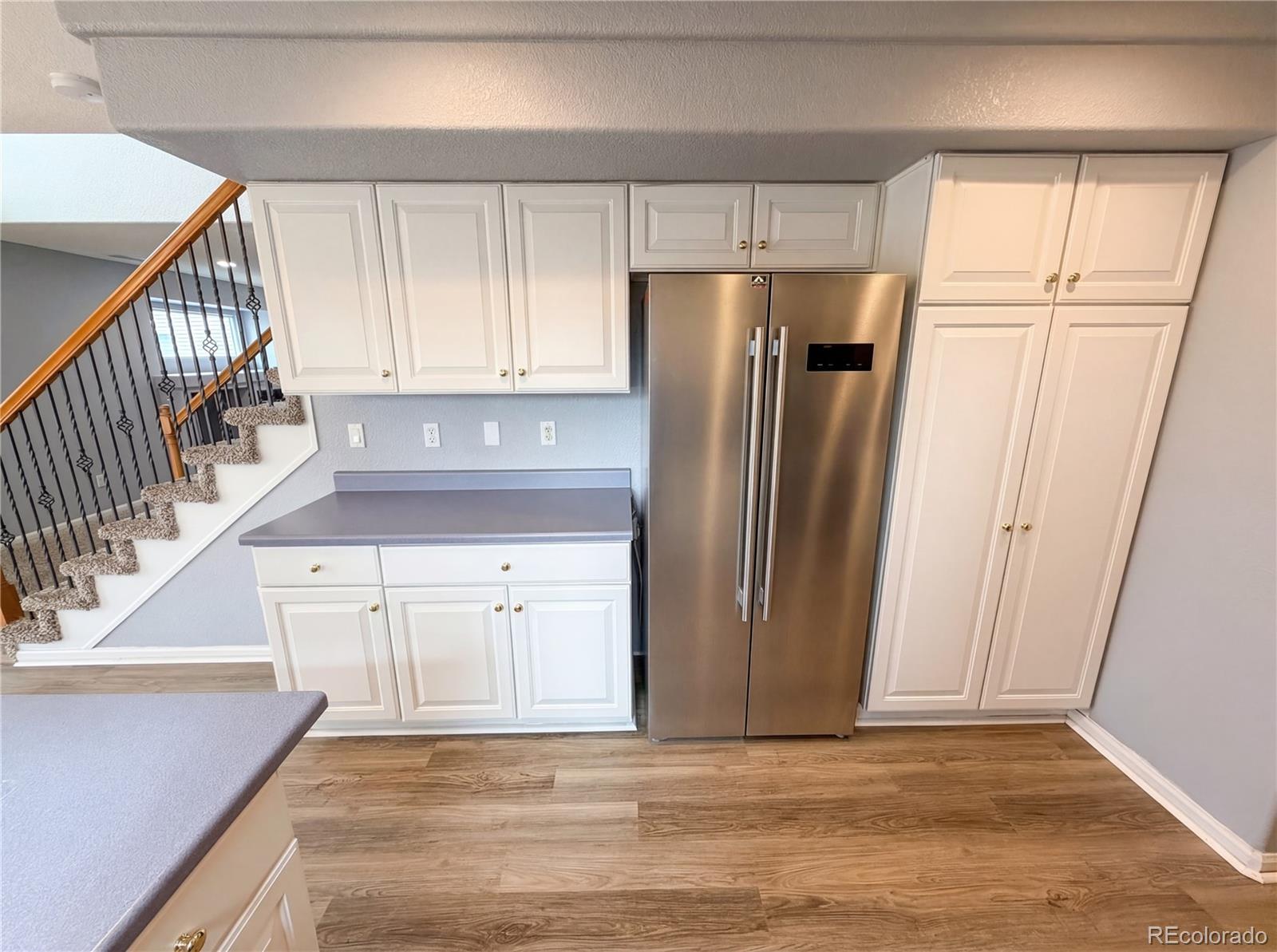 20000 Mitchell Place, Unit 45 Denver, CO 80249 - Photo 16 of 29 a view of a kitchen with white cabinets and refrigerator