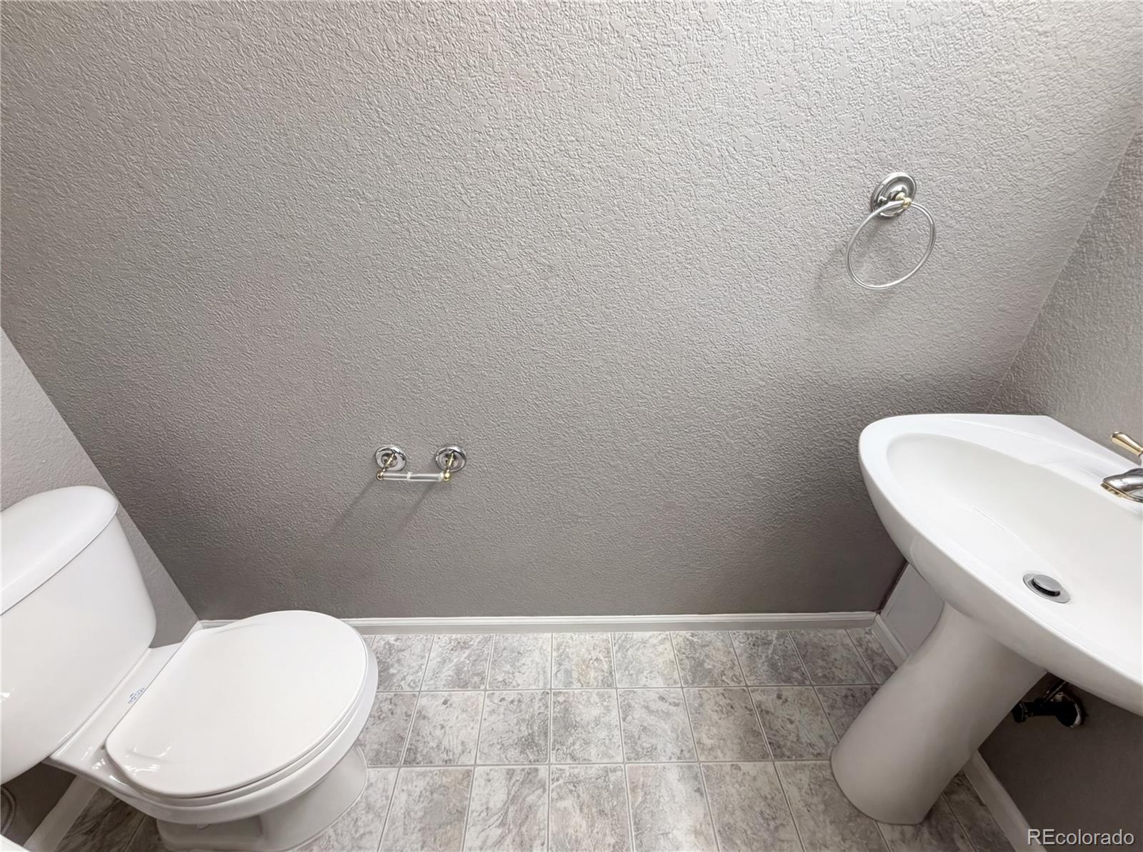 20000 Mitchell Place, Unit 45 Denver, CO 80249 - Photo 17 of 29 a white toilet sitting next to a bathroom sink