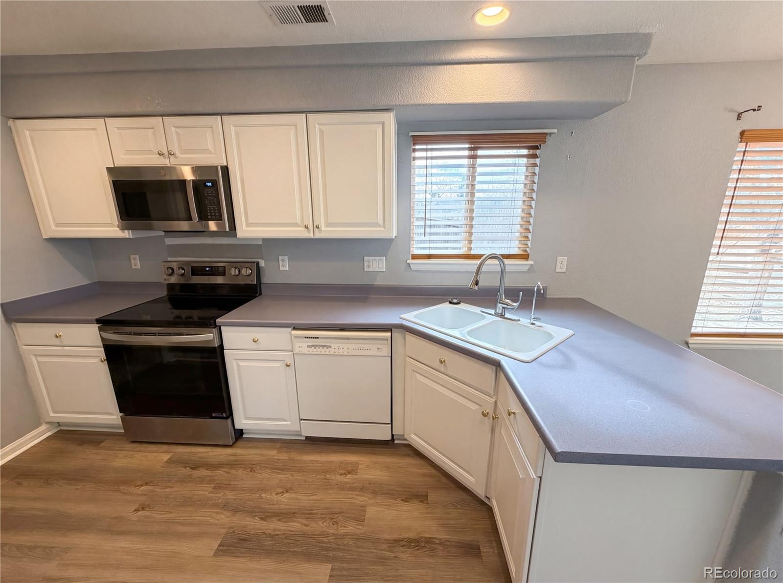 20000 Mitchell Place, Unit 45 Denver, CO 80249 - Photo 2 of 29 a kitchen with stainless steel appliances granite countertop a sink stove and microwave