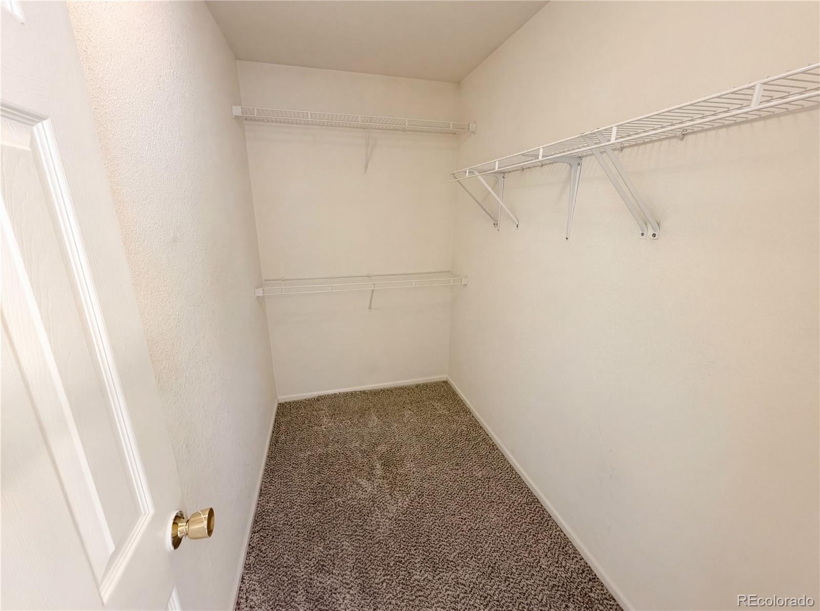 20000 Mitchell Place, Unit 45 Denver, CO 80249 - Photo 22 of 29 a view of a room with racks on the wall