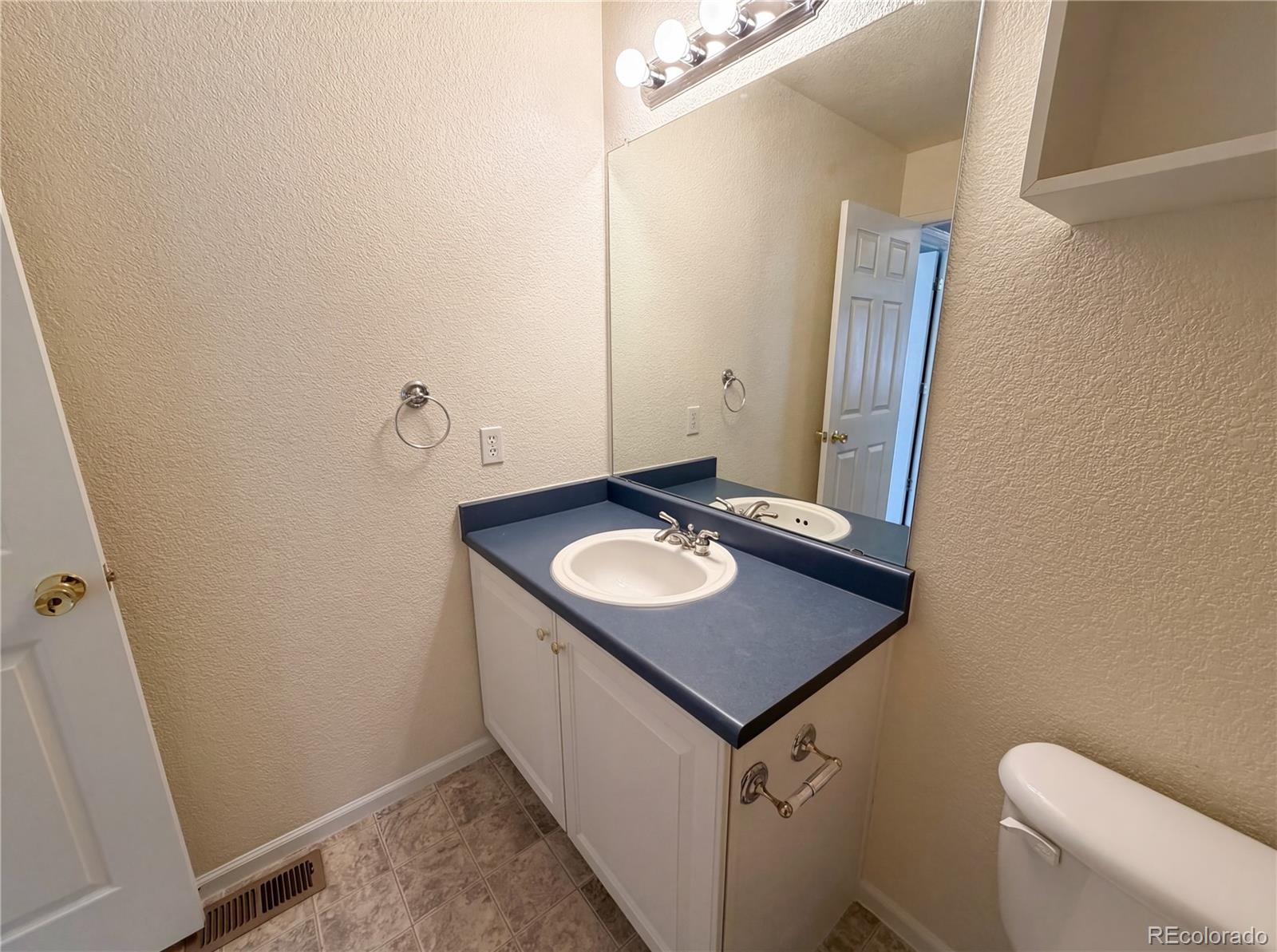 20000 Mitchell Place, Unit 45 Denver, CO 80249 - Photo 27 of 29 a bathroom with a sink toilet and mirror