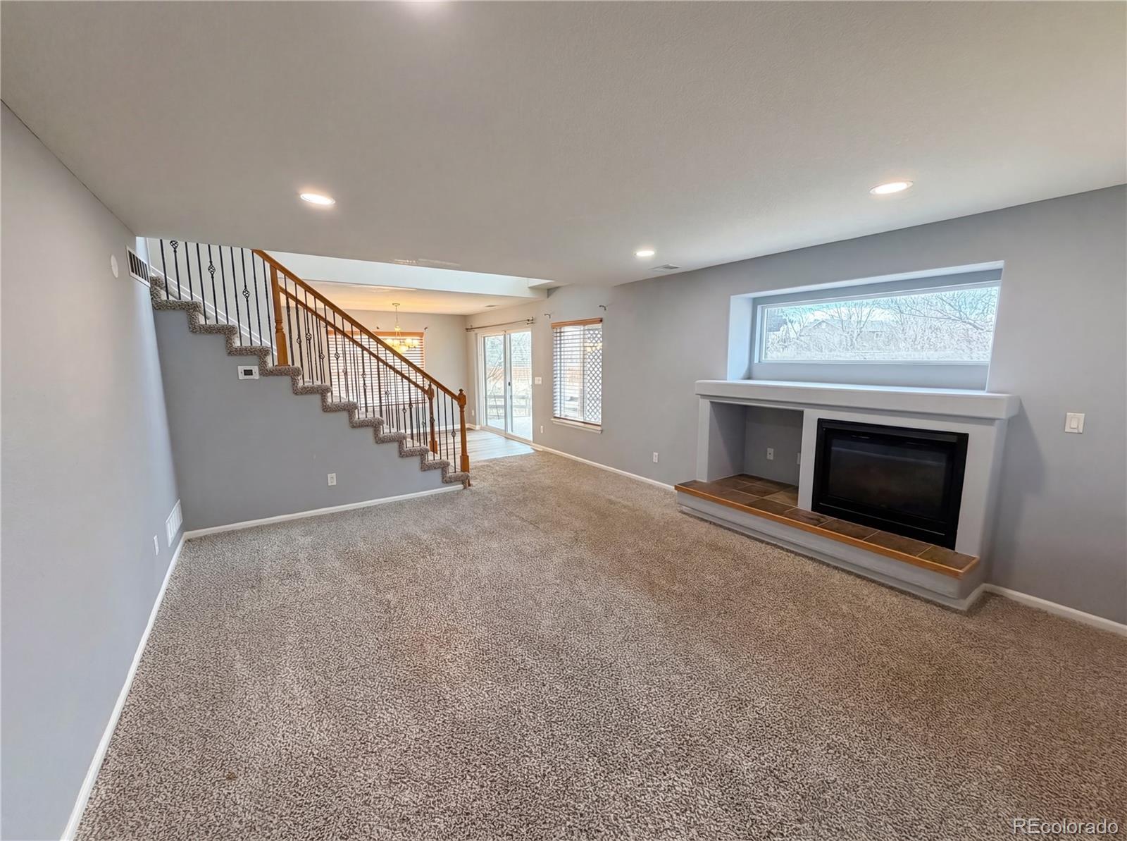 20000 Mitchell Place, Unit 45 Denver, CO 80249 - Photo 3 of 29 a view of empty room with fireplace and stairs