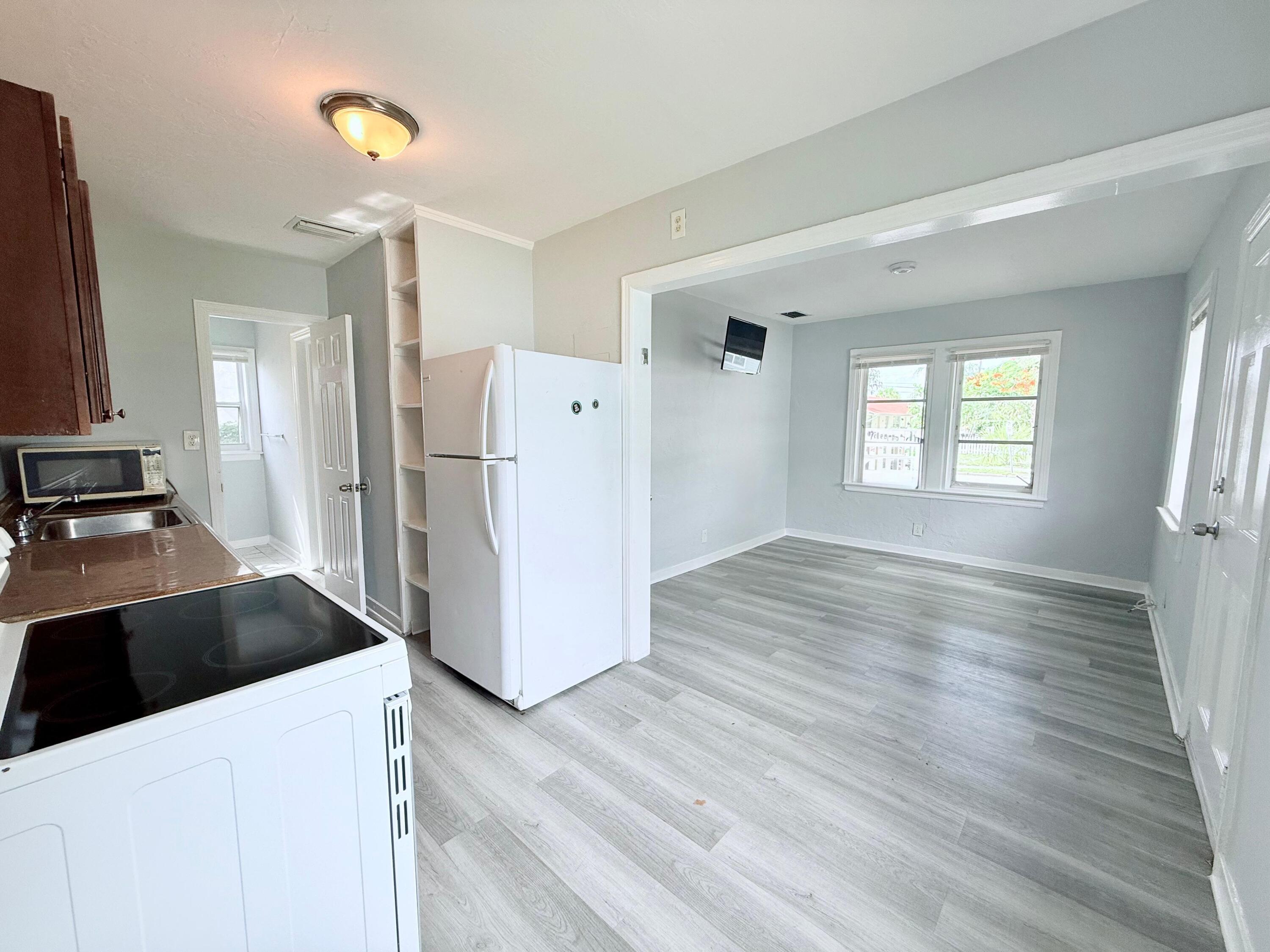 517 Kanuga Drive, Unit 1 West Palm Beach, FL 33401 - Photo 11 of 13 a kitchen with a refrigerator and a stove top oven