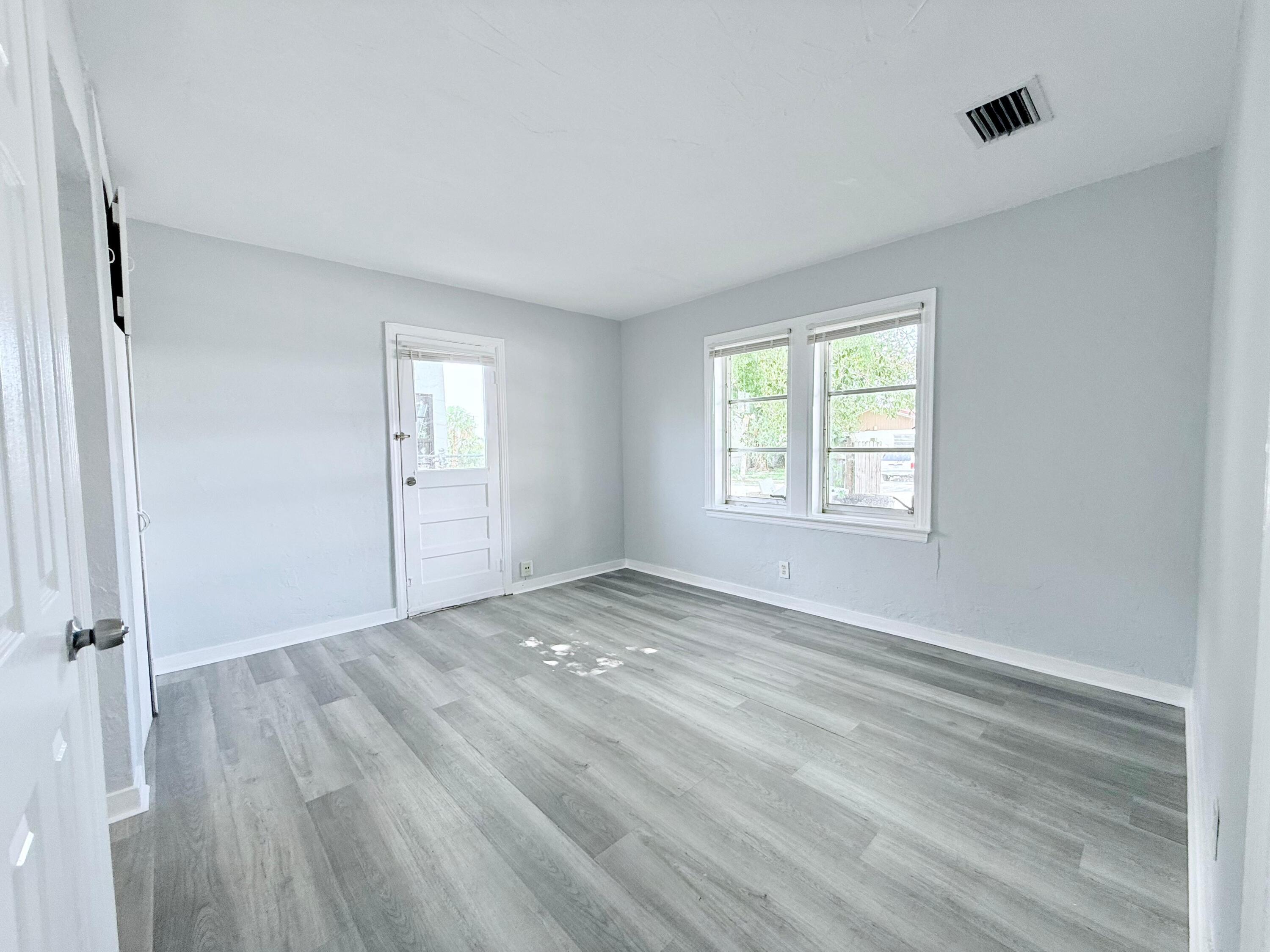 517 Kanuga Drive, Unit 1 West Palm Beach, FL 33401 - Photo 13 of 13 an empty room with windows and closet