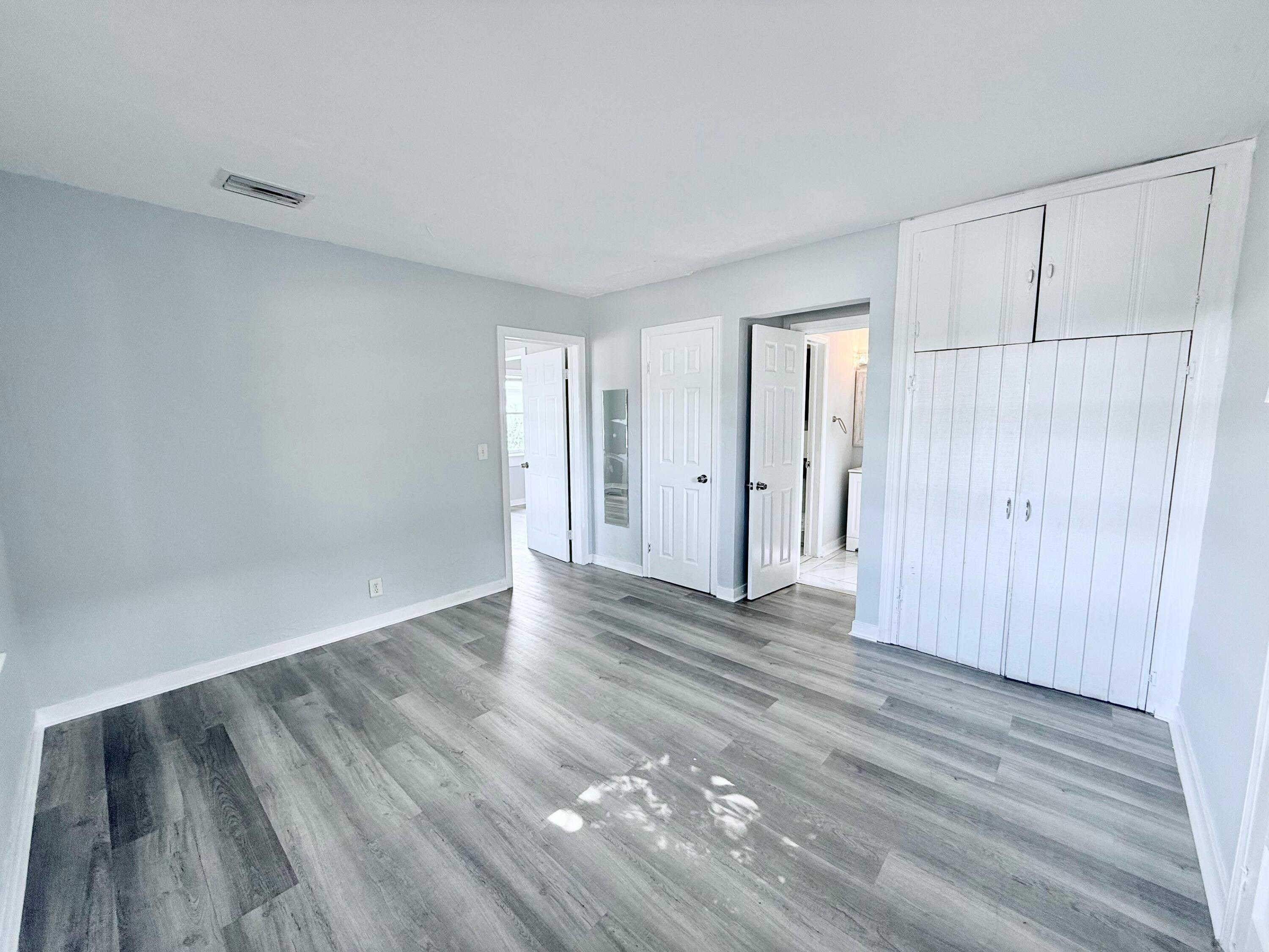 517 Kanuga Drive, Unit 1 West Palm Beach, FL 33401 - Photo 2 of 13 a view of an empty room with wooden floor