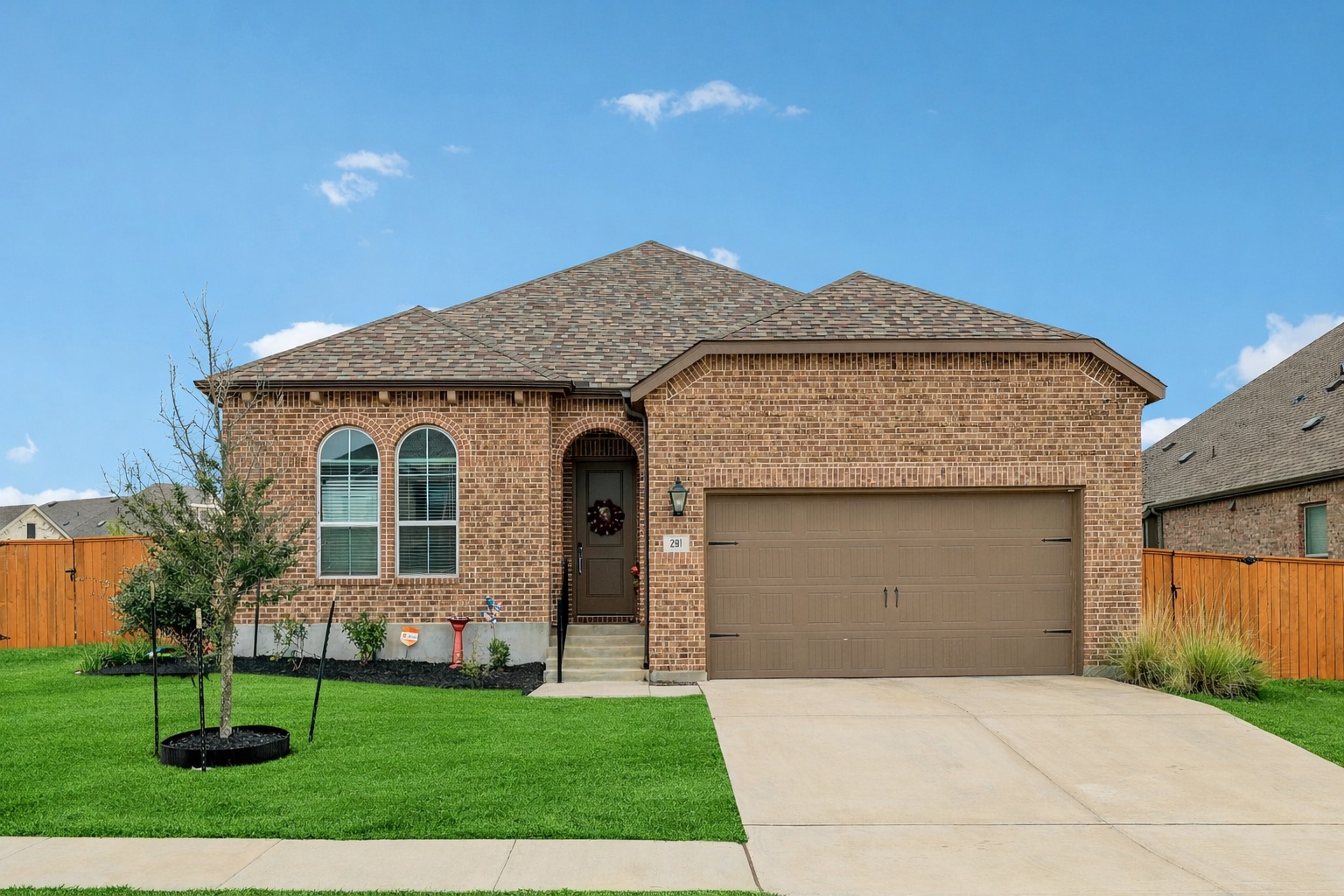 291 Billowing Way Kyle, TX 78640 - Photo 1 of 20 a front view of a house with a garden