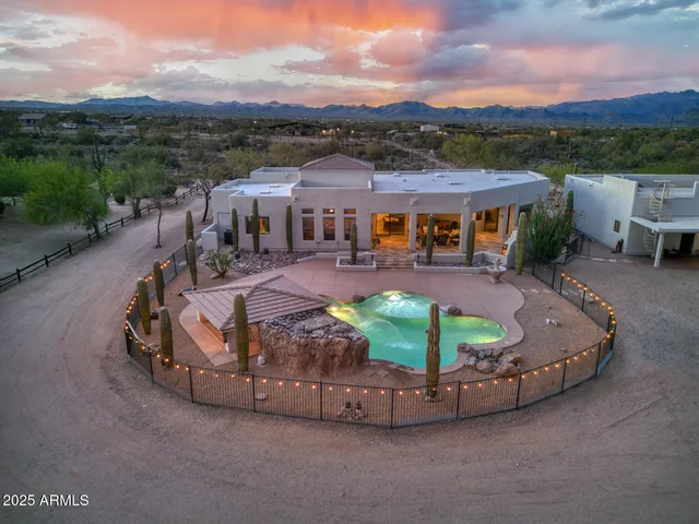 a living room with furniture large window and wooden floor