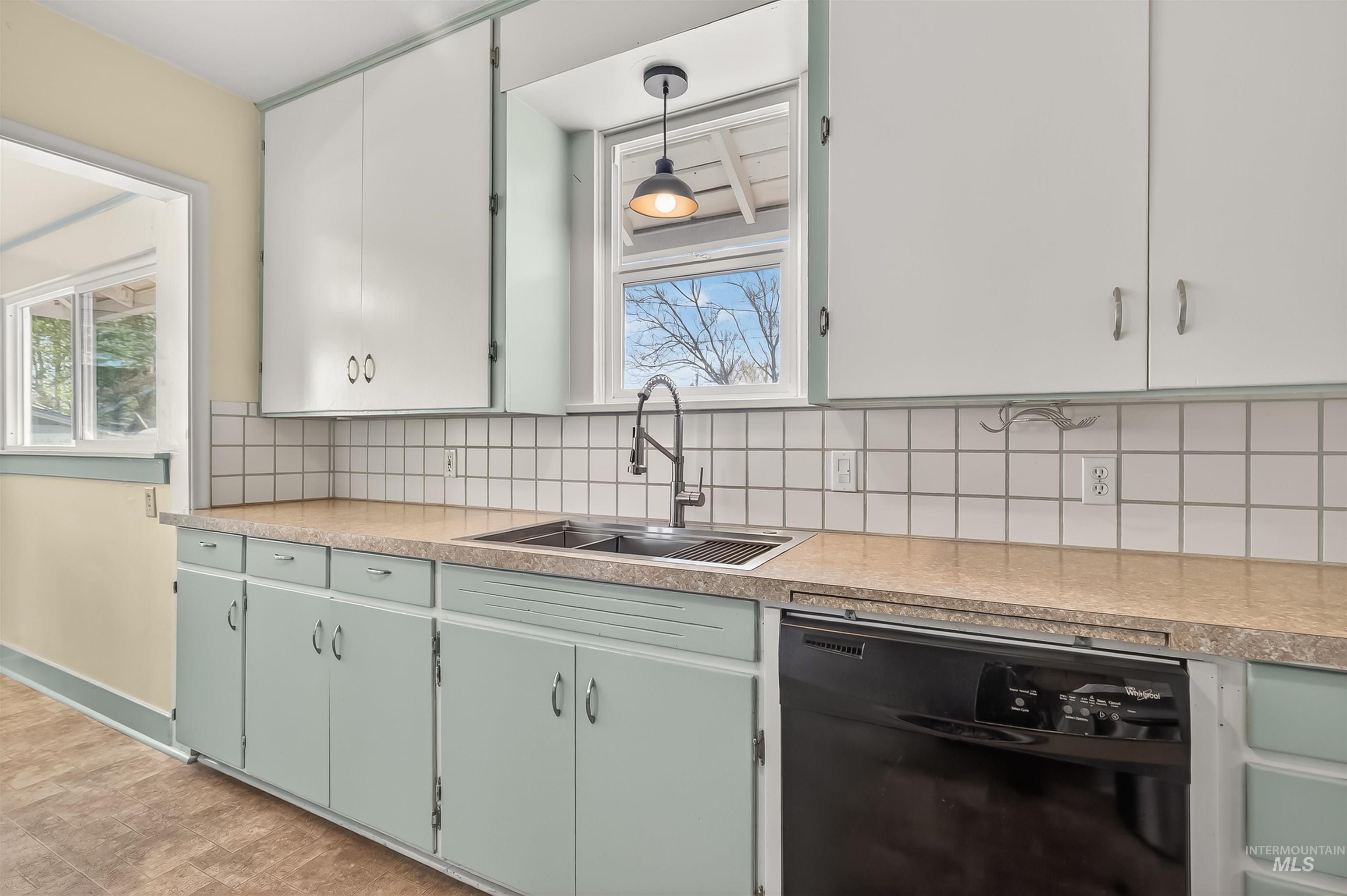 921 3rd Street Clarkston, WA 99403 - Photo 14 of 39 Kitchen featuring light countertops, dishwasher, tasteful backsplash, and healthy amount of natural light