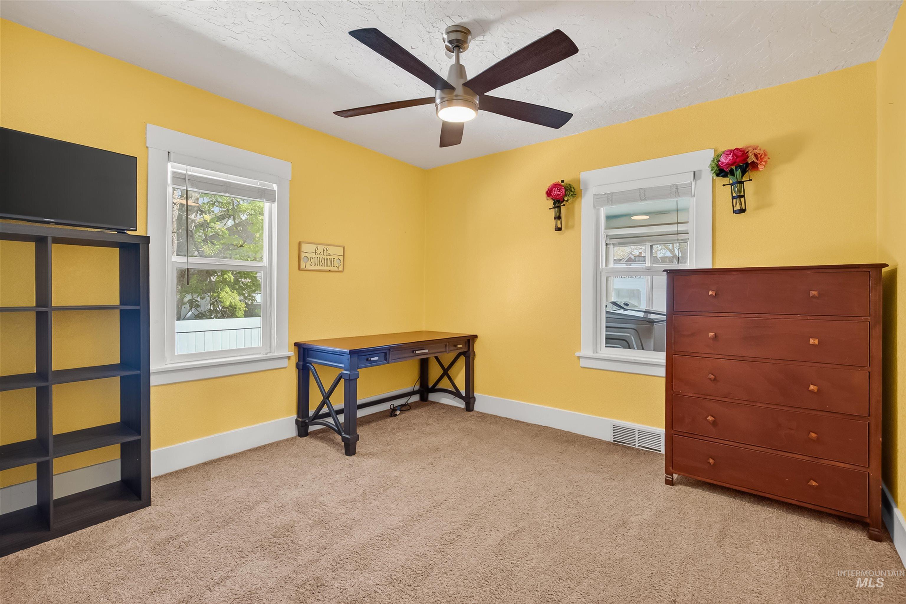 921 3rd Street Clarkston, WA 99403 - Photo 18 of 39 Bedroom featuring light colored carpet, ceiling fan, and a textured ceiling