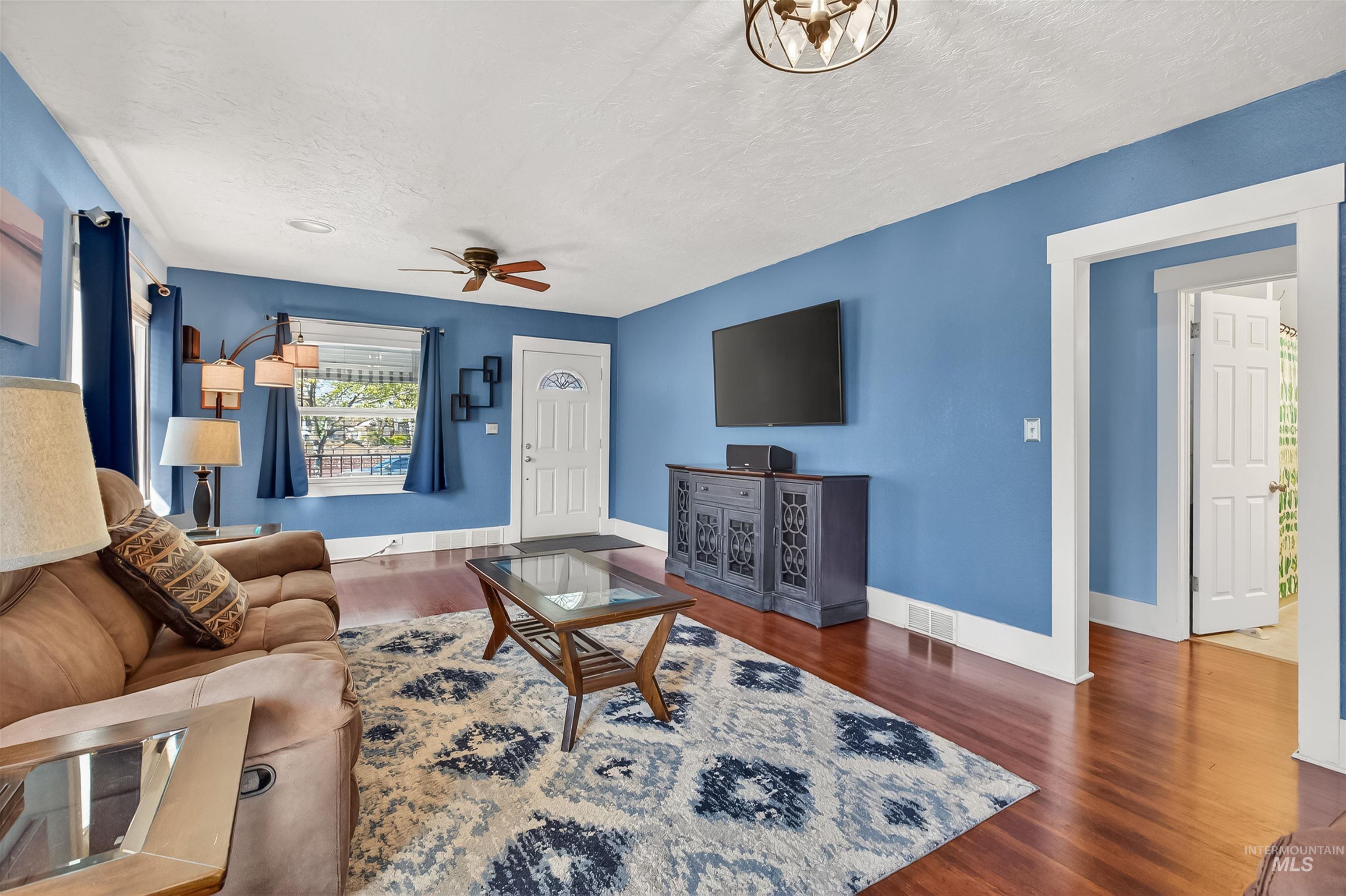 921 3rd Street Clarkston, WA 99403 - Photo 2 of 39 Living room featuring dark wood-style flooring, a ceiling fan, and a textured ceiling