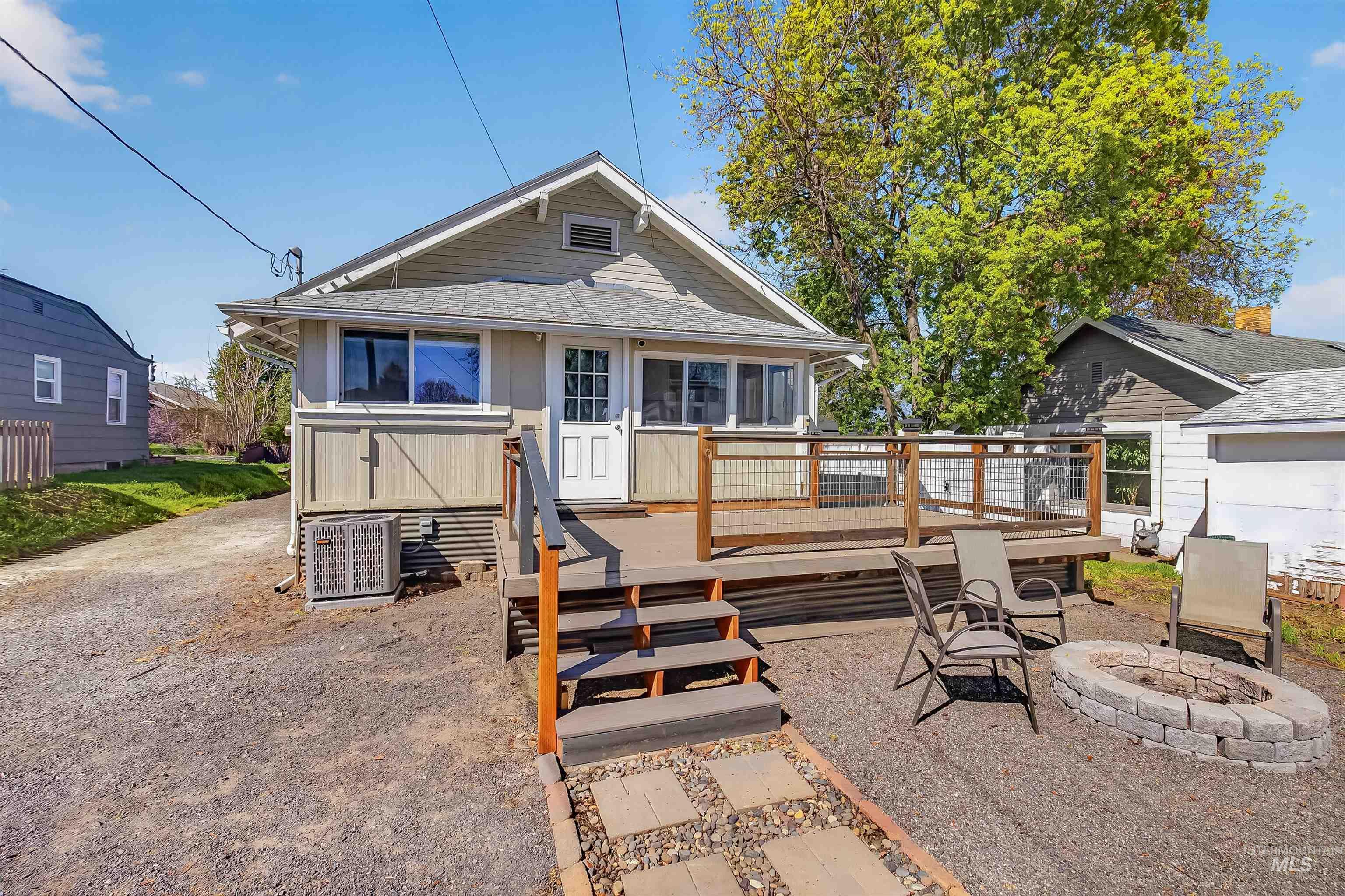 921 3rd Street Clarkston, WA 99403 - Photo 34 of 39 Rear view of house with a wooden deck, an outdoor fire pit, and roof with shingles