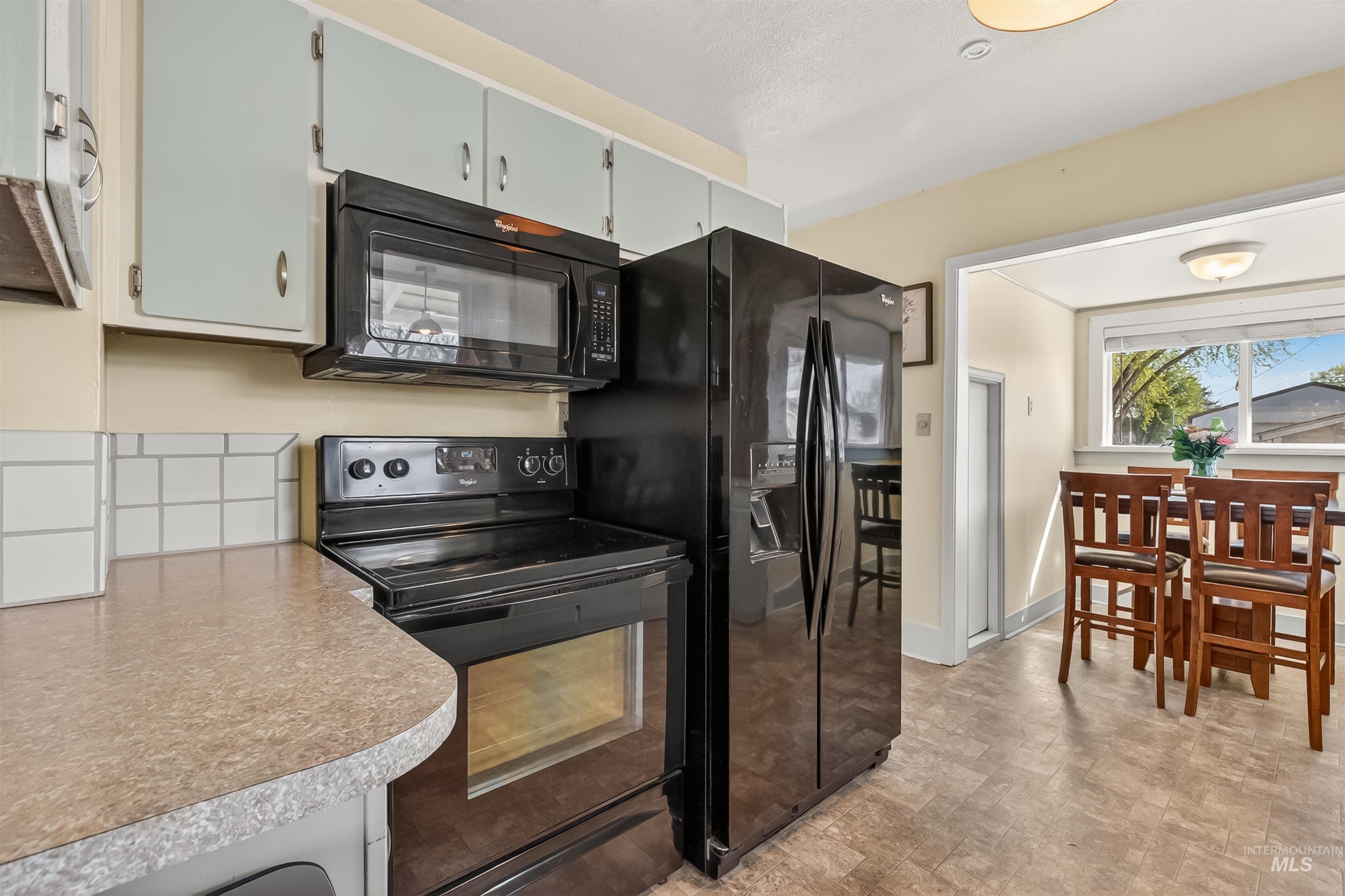 921 3rd Street Clarkston, WA 99403 - Photo 10 of 39 Kitchen with black appliances and light countertops