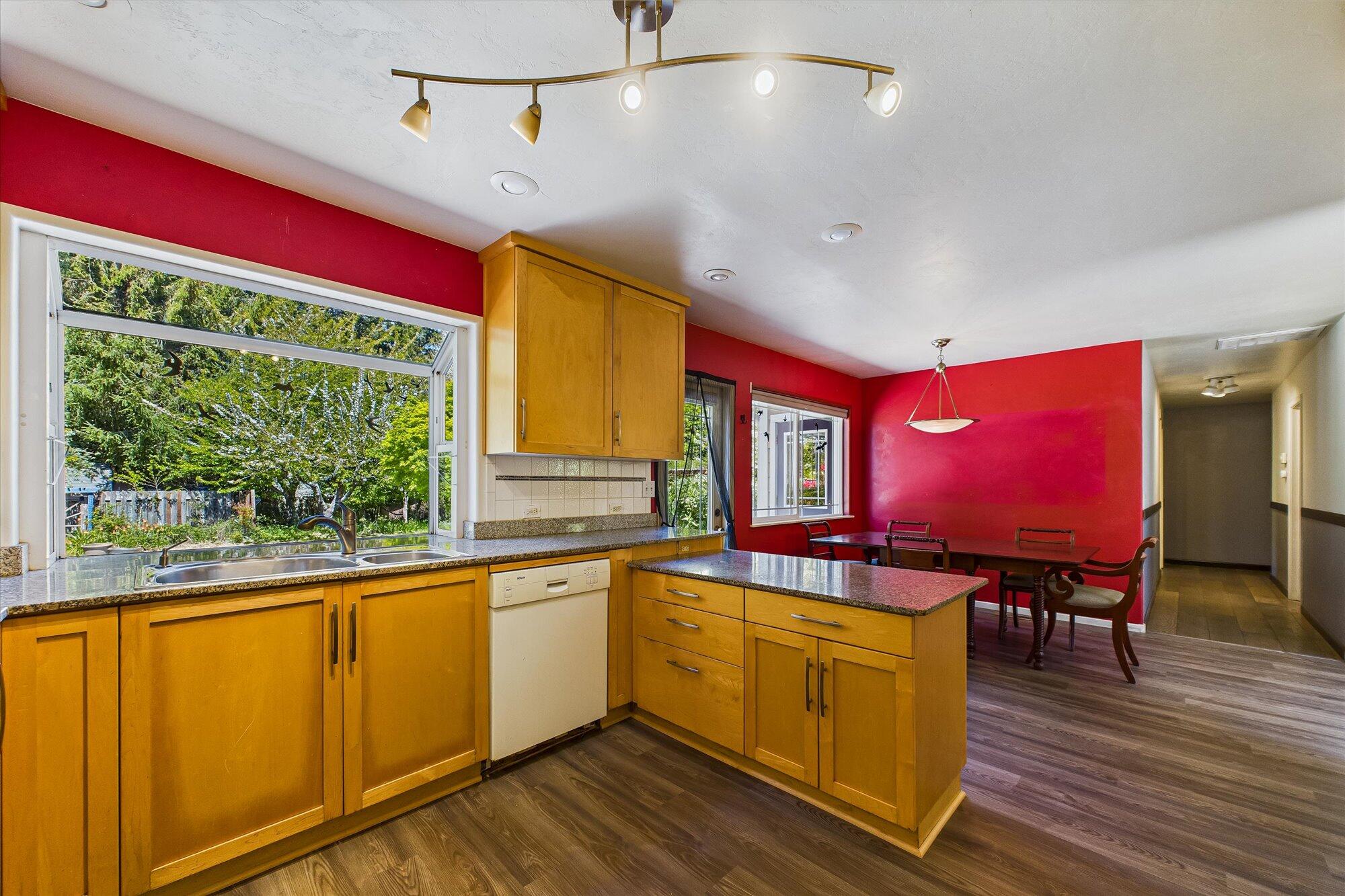 1945 Grange Road McKinleyville, CA 95519 - Photo 26 of 62 a kitchen with kitchen island granite countertop a stove a sink and wooden cabinets
